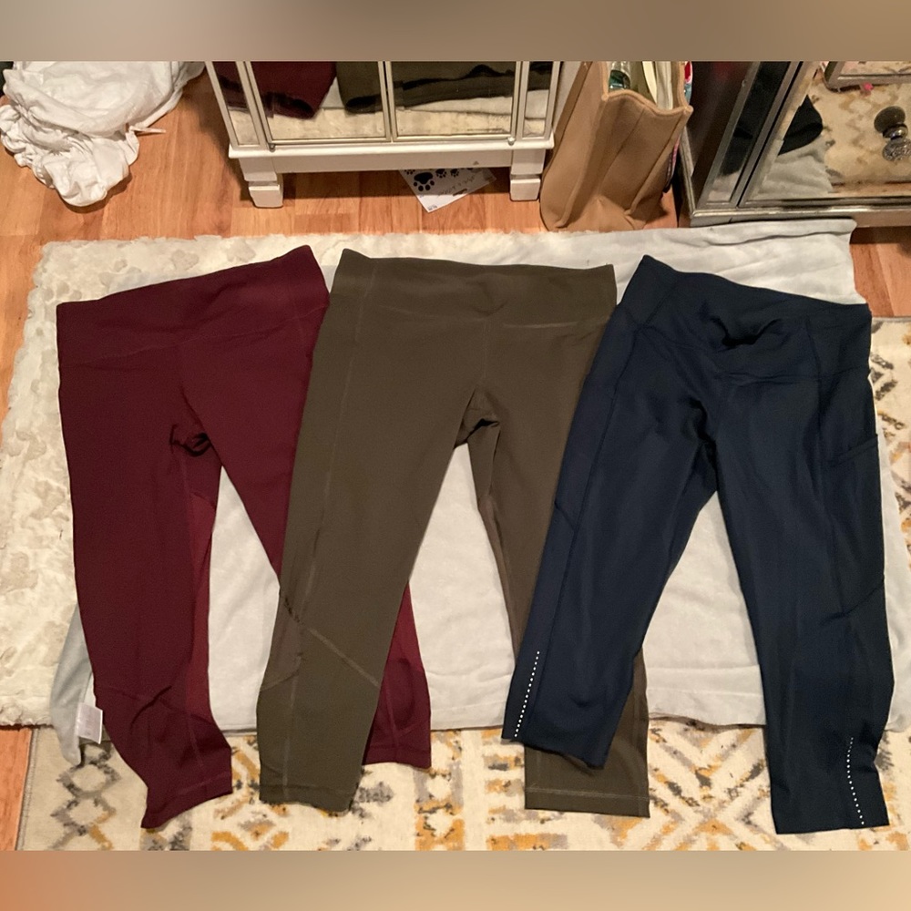 Three pairs of Lululemon crop style and burgundy, olive and blue gently worn